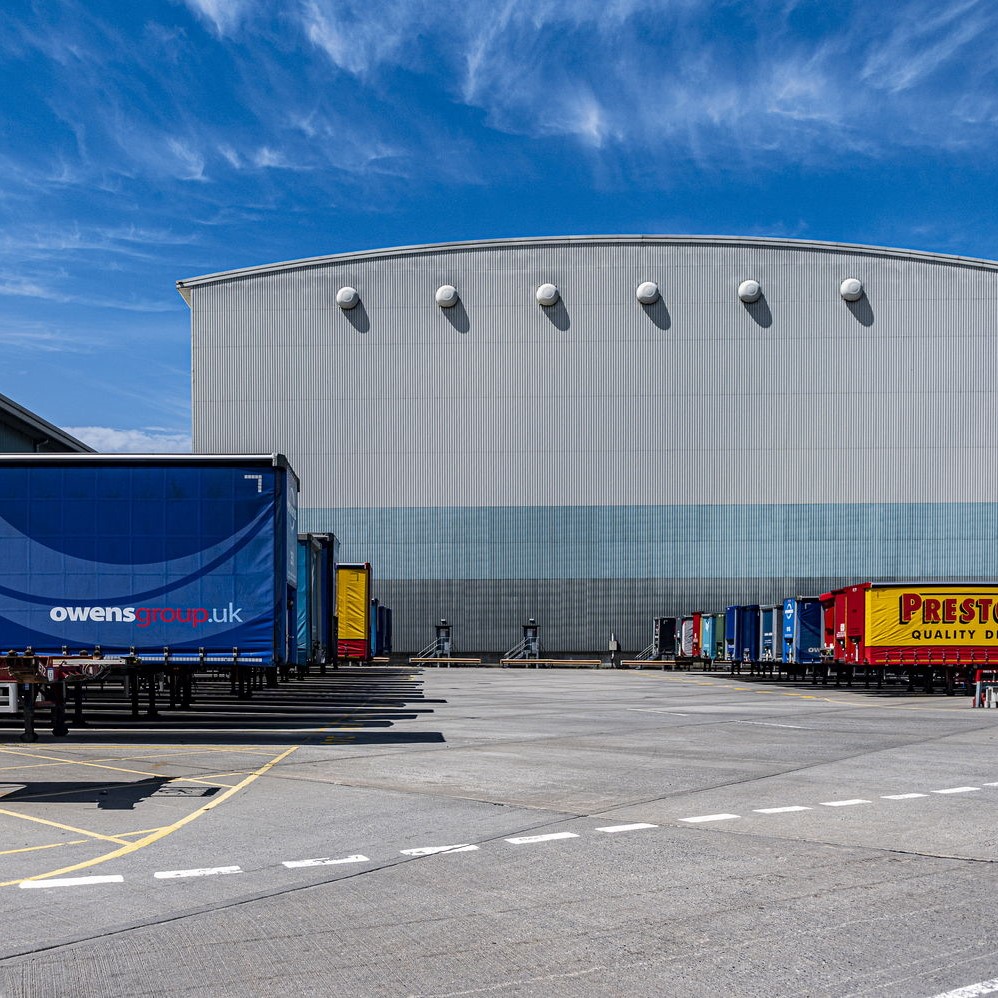 A lorry loading area behind a warehouse
